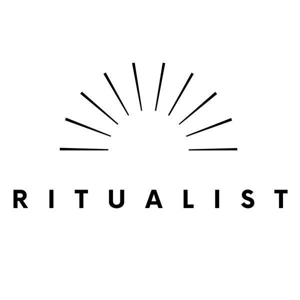 Logo of 'Ritualist' with sunburst design and bold text on a white background
